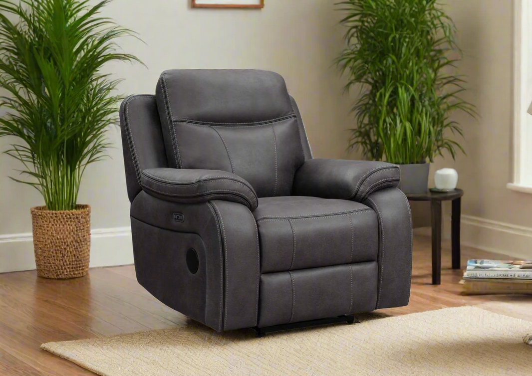 Gray recliner chair in a living room setting with plants and a small table.