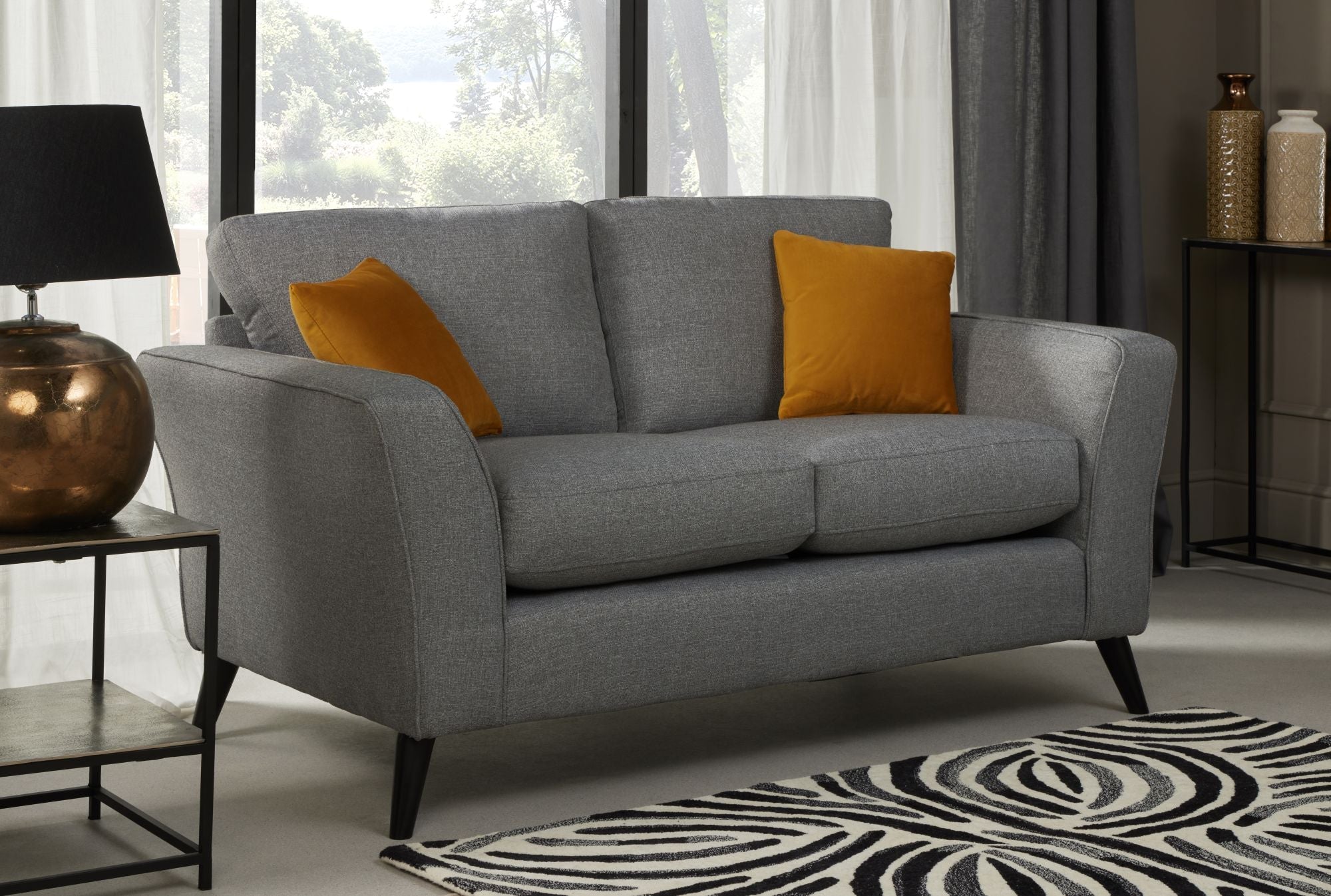 Charcoal fabric 2 seater sofa on black raised legs with 2 ocre scatter cushions