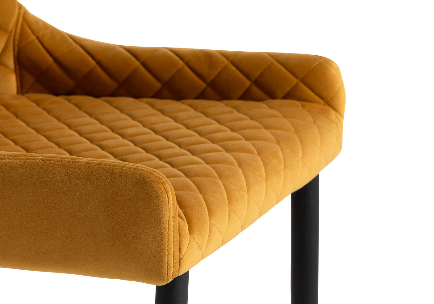 Mustard yellow quilted chair with black legs on a white background