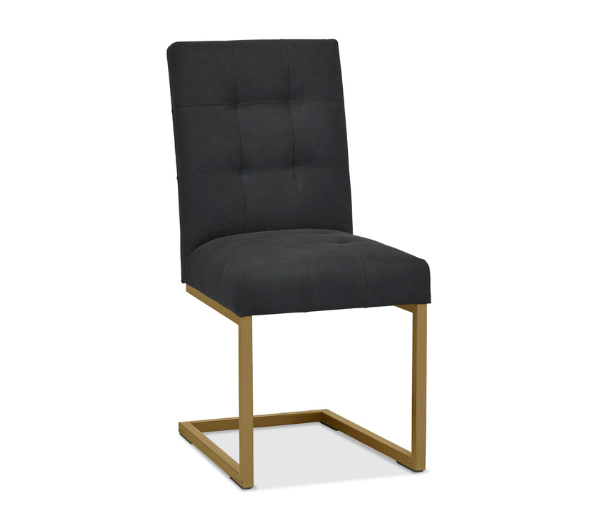 Front, angled and closer view of the Lindos Fabric Dining Chairs with black square-stitched upholstery and brass legs.
