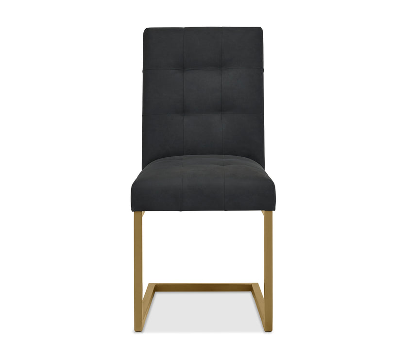 Front view of the Lindos Fabric Dining Chairs with black square-stitched upholstery and brass legs.
