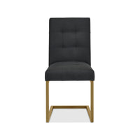 Front view of the Lindos Fabric Dining Chairs with black square-stitched upholstery and brass legs.
