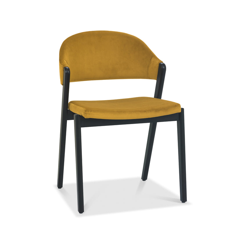 Front and angled image of the Candice Velvet Dining Chair with curved back and dark legs.