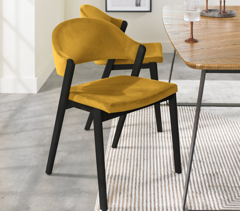 Angled Candice Velvet Dining Chair with curved back and dark legs.