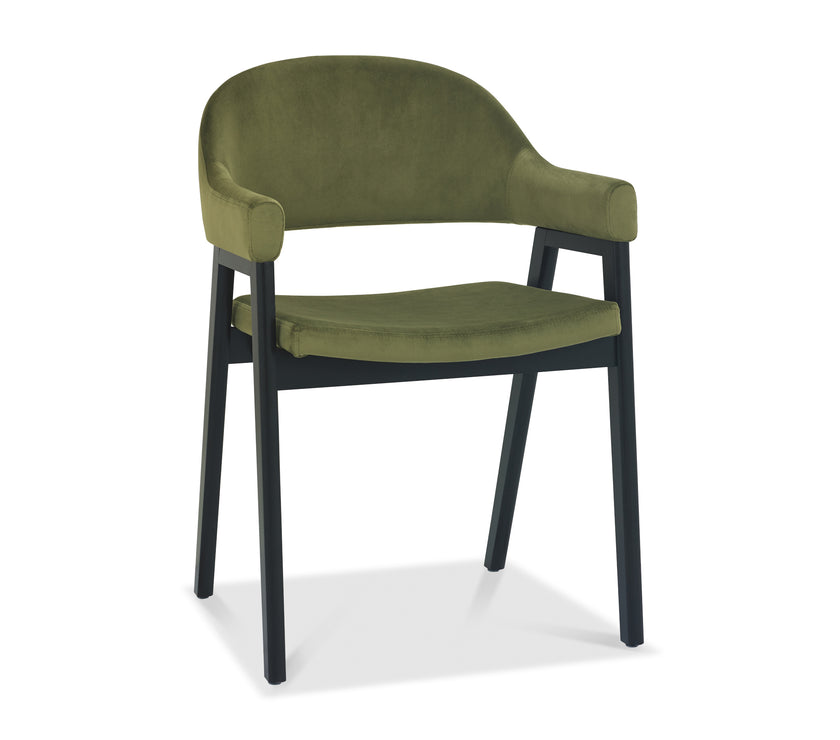 Angled and front image of the Candice Velvet dining chairs with curved back, armrests, and dark legs.