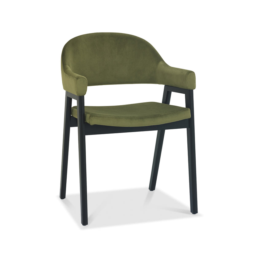 Angled and front image of the Candice Velvet dining chairs with curved back, armrests, and dark legs.