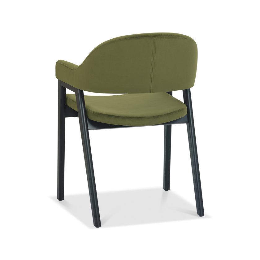 Angled and back image of the Candice Velvet dining chairs with curved back, armrests, and dark legs.