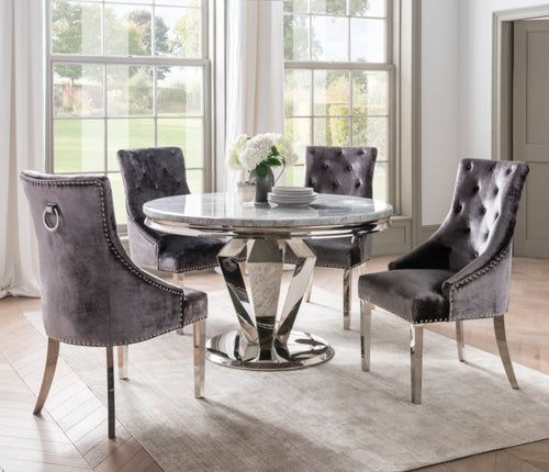 Image of the Belvedere Knockerback Velvet Dining Chairs around a round dining table