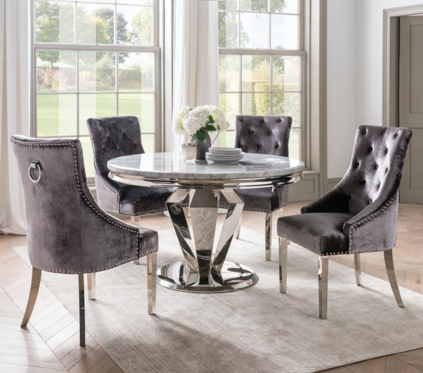 Image of the Belvedere Knockerback Velvet Dining Chairs around a round dining table