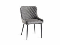 Angled image of the Lozanne Faux Leather Dining Chairs with diamond stitching and metal legs.