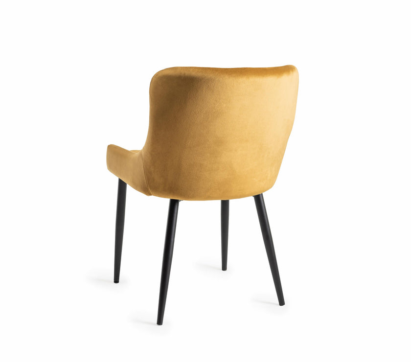 Back image of our Lozanne Velvet Dining Chair in mustard with diamond stitching and black legs.