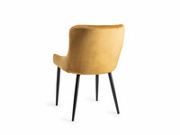 Back image of our Lozanne Velvet Dining Chair in mustard with diamond stitching and black legs.