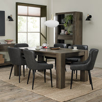 Image of the Lozanne Faux Leather Dining Chairs with diamond stitching and metal legs in a set with other chairs and a table.