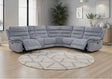 Grey recliner sofa in a living room with a round rug and décor elements.
