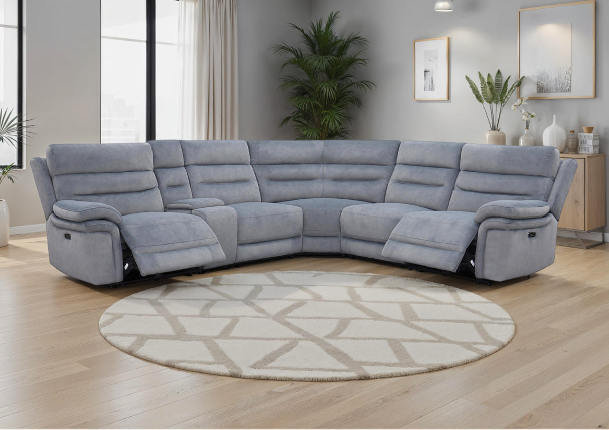 Grey recliner sofa in a living room with a round rug and décor elements.