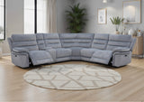 Grey recliner sofa in a living room with a round rug and décor elements.