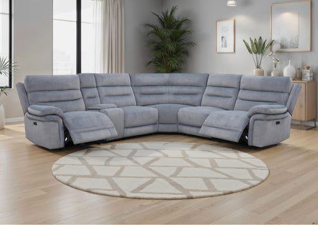 Grey recliner sofa in a living room with a round rug and décor elements.