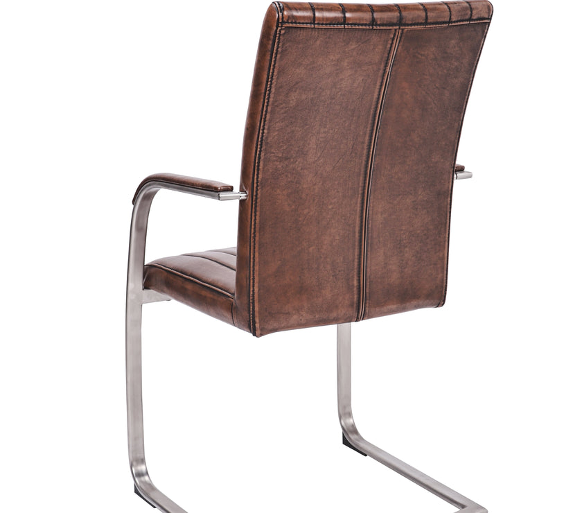 Angled and back view of the Triumph Cantilever Faux Leather Dining Chairs with armrests and steel legs.