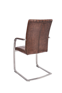 Angled and back view of the Triumph Cantilever Faux Leather Dining Chairs with armrests and steel legs.