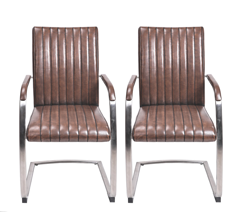 Front view of the Triumph Cantilever Faux Leather Dining Chairs with armrests and steel legs.