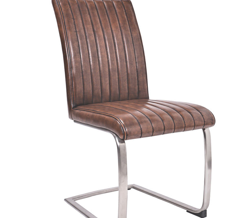 Angled view of the Vespa Cantilever Faux Leather Dining Chairs with curved back and steel legs.