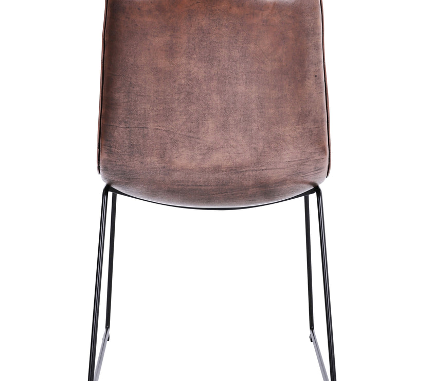 Back view of the Atlas Faux Leather Dining Chairs with curved back, tan upholstery, and black metal legs.