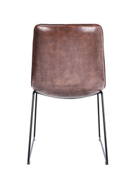 Back view of the Atlas Faux Leather Dining Chairs with curved back, tan upholstery, and black metal legs.