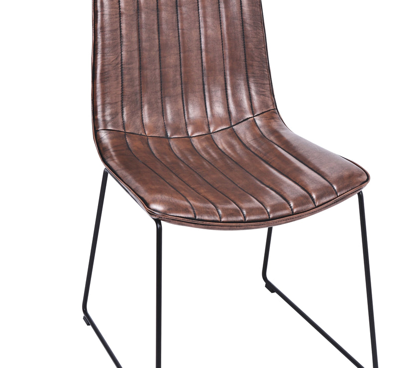 Angled view of the Atlas Faux Leather Dining Chairs with curved back, tan upholstery, and black metal legs.