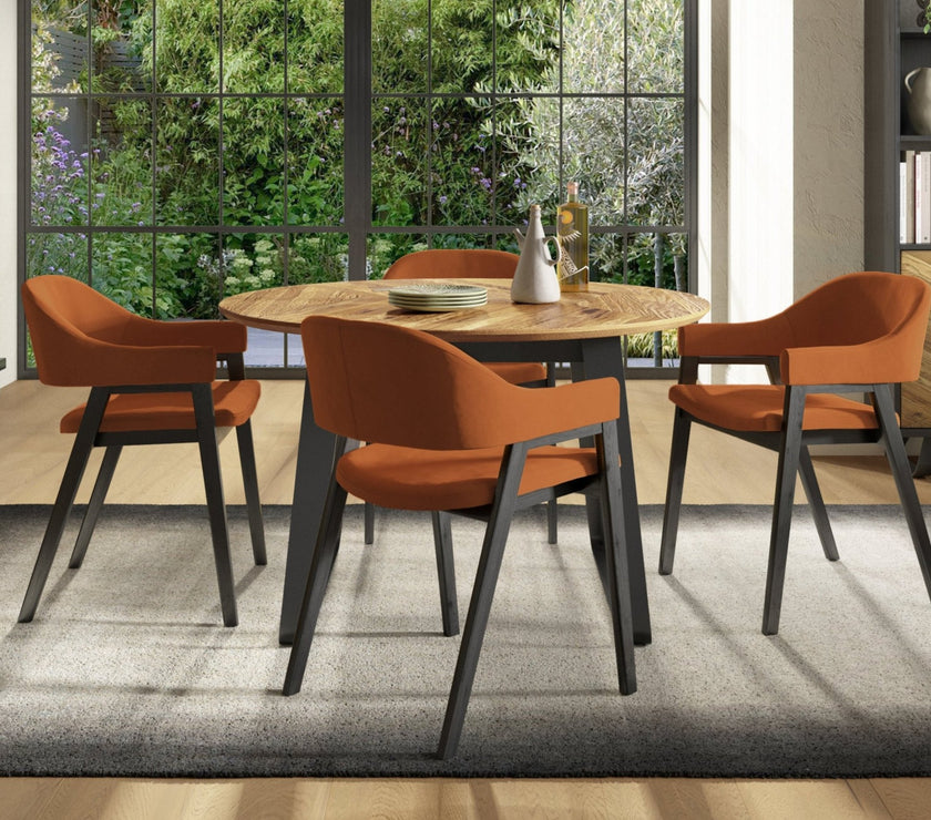 Image of the Henderson Round Dining Table being styled with NCF's Dining Furniture.