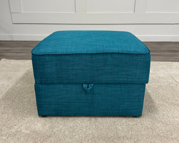 Front view of the Felix Storage Stool in a room.