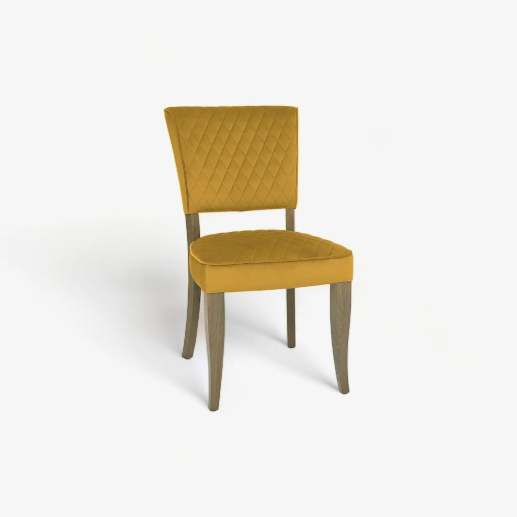 Angled and front image of the Landon Fumed Oak Dining Chairs with dark oak frame and mustard velvet seat.