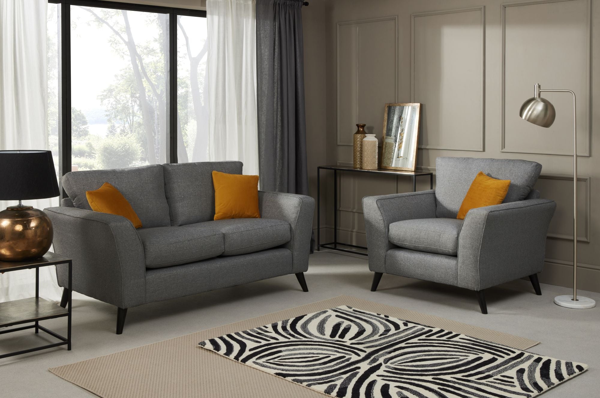 Libby 2 seater sofa and Armchair in Charcoal show in a room setting 
