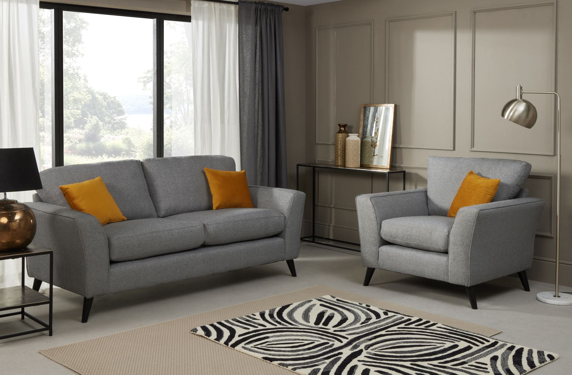 Libby 3 seater and armchair in charcoal shown in a room setting 
