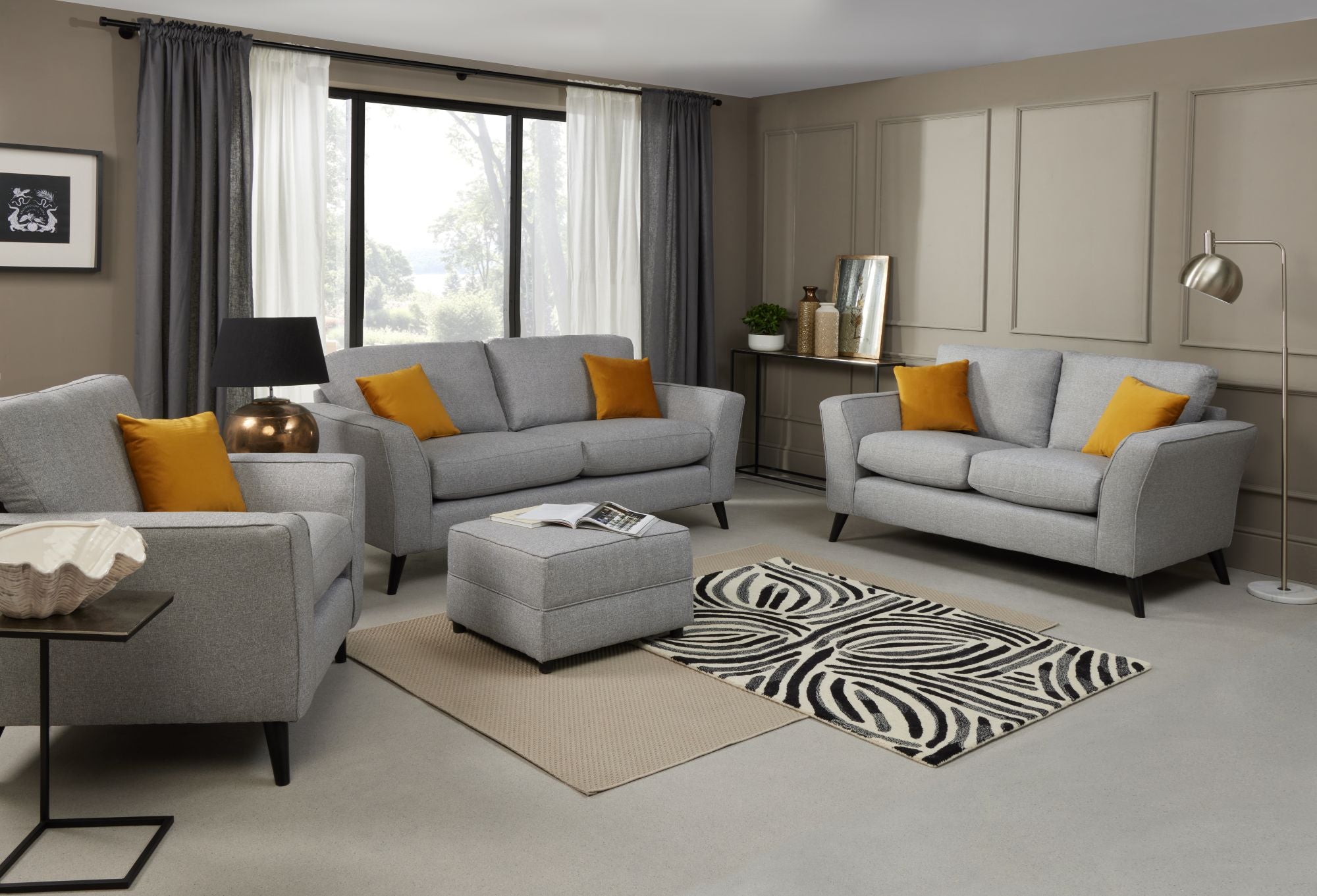 Libby 2 seater, 3 seater, armchair and footstool in Silver shown in a room setting 