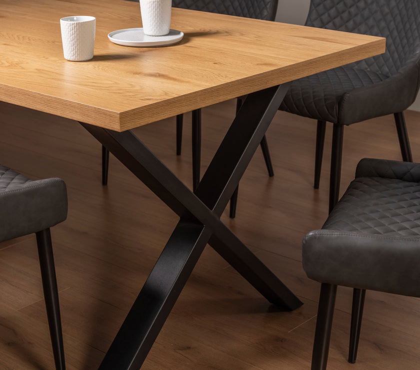 Side view of the Nancy Dining Table styled with black dining chairs.