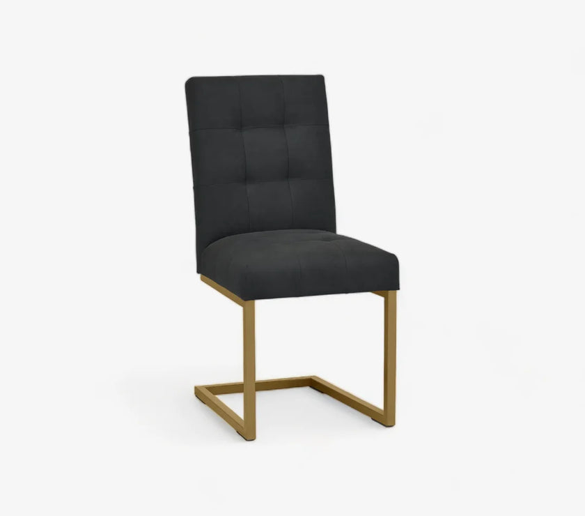 Angled and front view of the Lindos Fabric Dining Chairs with black square-stitched upholstery and brass legs.

