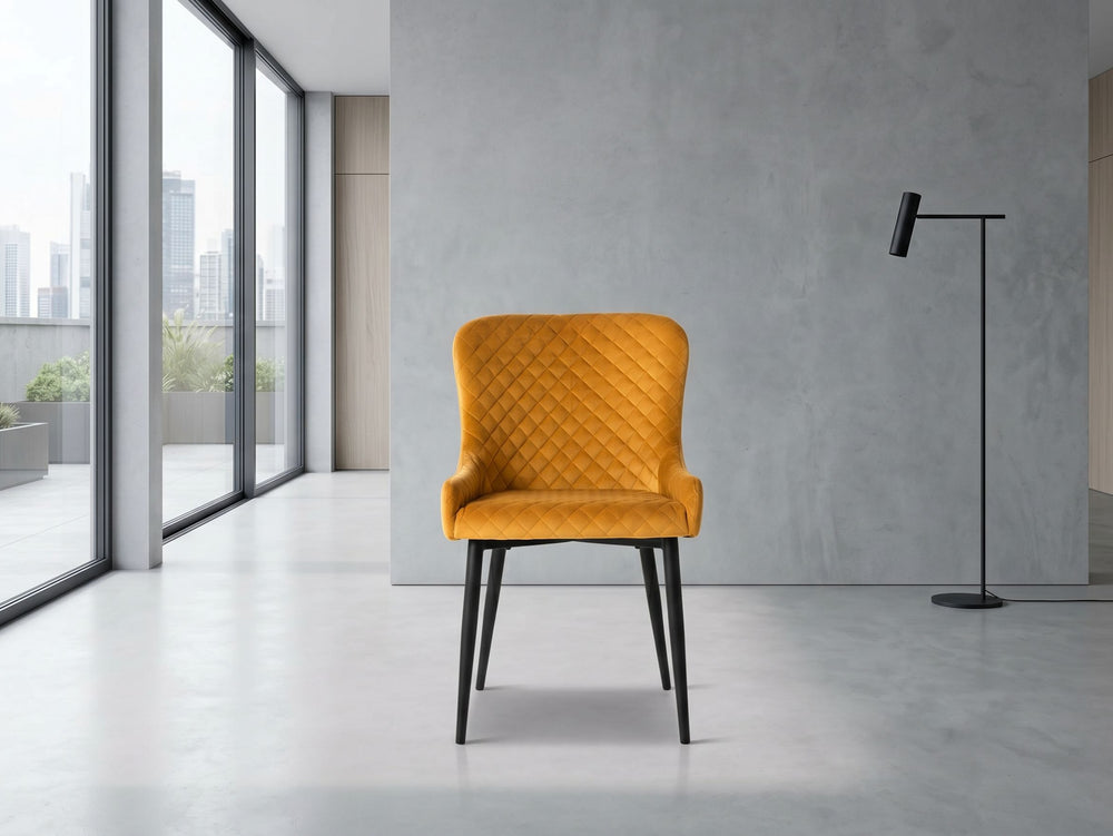 Mustard yellow chair in a modern room with large windows and a gray wall.