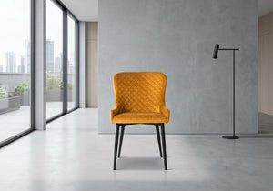 Mustard yellow chair in a modern room with large windows and a gray wall.