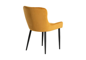 Back view of a mustard yellow velvet dining chair 