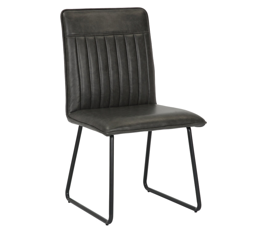 Angled image of the Black Manhattan Faux Leather Dining Chair with black metal legs and high back