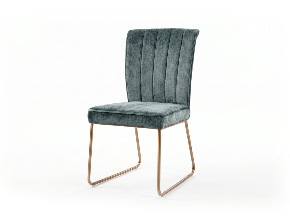 Green velvet upholstered chair with bronze legs on a white background
