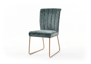 Green velvet upholstered chair with bronze legs on a white background