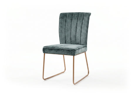 Green velvet upholstered chair with bronze legs on a white background