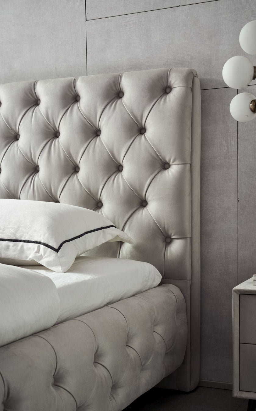 Close view of beige nubuk tufted head board and side rail