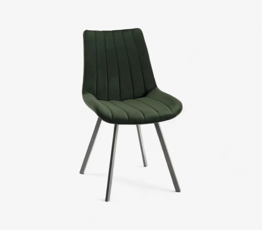 Front and angled image of the Savio Dining Chairs in green velvet with vertical stitching and metal legs.