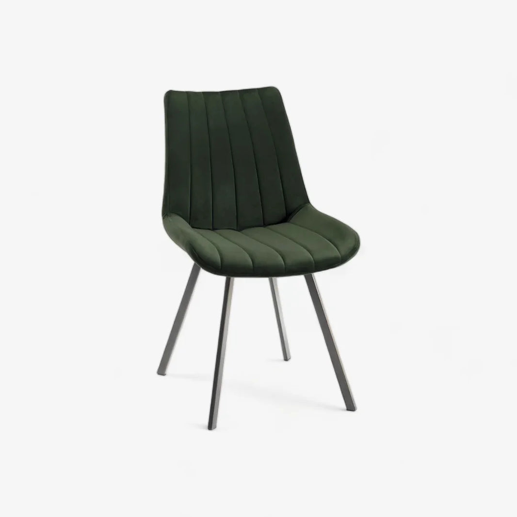 Front and angled image of the Savio Dining Chairs in green velvet with vertical stitching and metal legs.