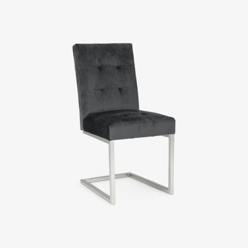 Front image of the Toulouse Velvet Dining Chairs with gunmetal fabric, chrome cantilever frame, and quilted button detailing.