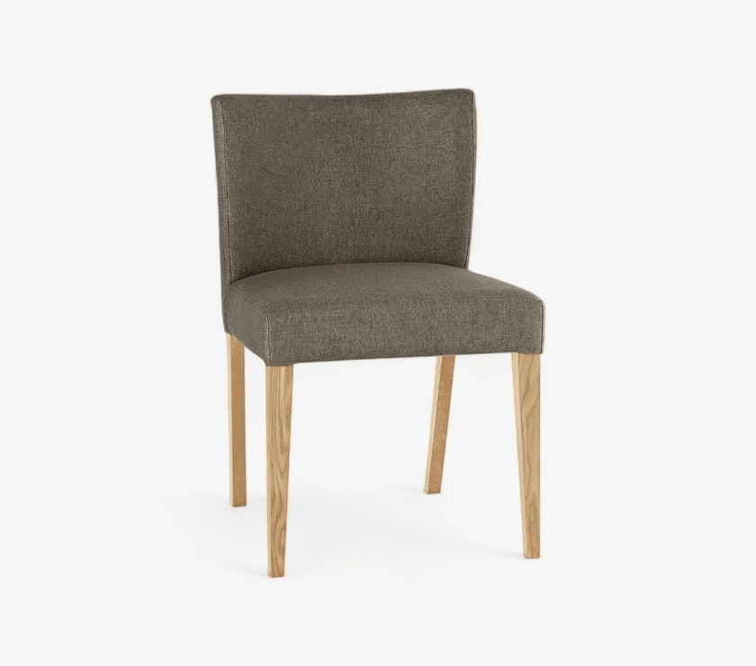 Angled and front view of the Turner Light Oak Dining Chairs with soft gold fabric and tapered light oak legs.

