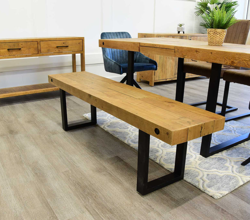 Angled view of NCF's oregon extendable dining table. This isn't just a dining table but a reclaimed wood dining table.  It is styled with the oregon dining bench and sideboard which illustrates how good they all look together. Also some of NCF's dining chairs are by the dining table.