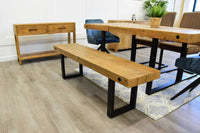 Angled view of NCF's oregon extendable dining table. This isn't just a dining table but a reclaimed wood dining table.  It is styled with the oregon dining bench and sideboard which illustrates how good they all look together. Also some of NCF's dining chairs are by the dining table.